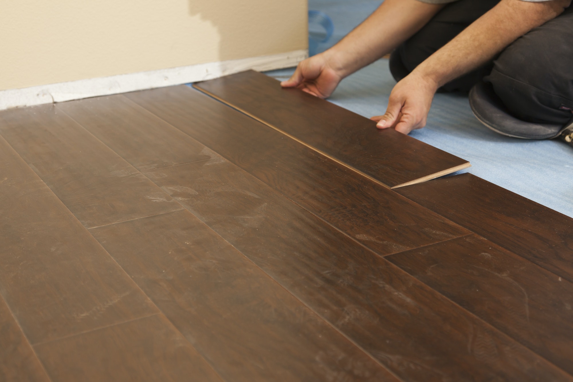 Man Installing New Laminate Wood Flooring