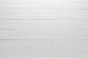 White wood table background, top view. Textured painted floor, board texture, wooden siding. Light